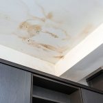 Stained ceiling showing water damage above cabinetry in a property, highlighting plumbing issues addressed by Super Plumbers.