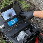 Portable inspection camera with live screen, used for plumbing inspections outdoors. Super Plumbers equipment.